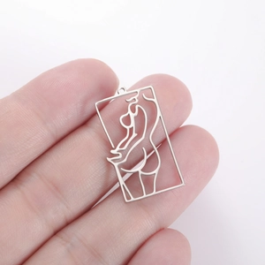Detailed view of silver rectangular cutout pendant with artistic female figure outline