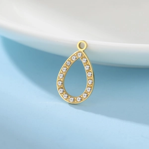 Detailed close-up of a gold teardrop pendant with sparkling cubic zirconia settings