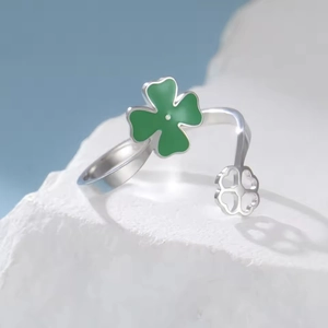 Adjustable silver clover open ring with green enamel and hollow clover charm on white stone