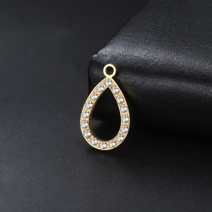 Golden teardrop pendant with sparkling crystals on black leather jewelry box
