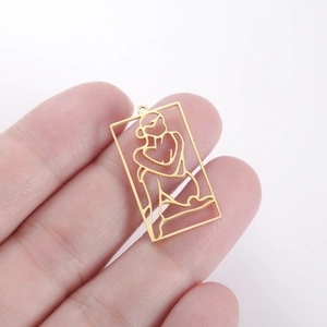 Detailed view of hollow rectangular pendant with artistic female silhouette line art