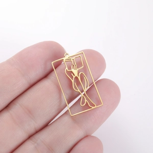 Close-up of a gold hollow rectangular pendant with minimalist artistic female silhouette