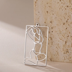 Detail shot of rectangular hollow pendant with minimalist woman silhouette on stone base