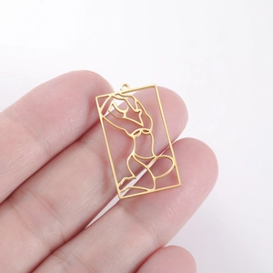 Detail of gold rectangular pendant with minimalist hollow-out female body art design