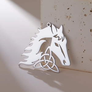 Detailed view of polished silver horse head pendant with Celtic knot hollow pattern