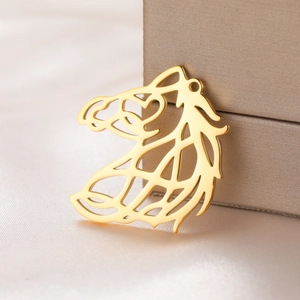 Polished gold hollow horse head pendant on elegant silk background for jewelry