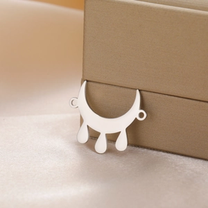 Polished stainless steel crescent moon pendant with teardrop charms on satin