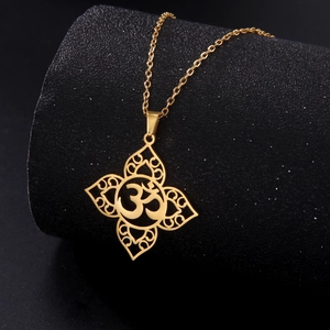 Golden stainless steel Om pendant necklace with mandala filigree on black display
