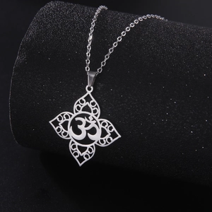 Retro stainless steel Om pendant necklace with hollow mandala design on black stand