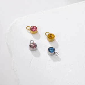 Detail view of multi-colored birthstone charms with gold and silver stainless steel bases