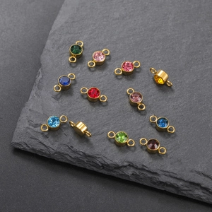 Macro shot of colorful birthstone connectors in gold double-hole stainless steel settings