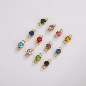Twelve colorful rhinestones birthstone charms in gold-plated stainless steel settings