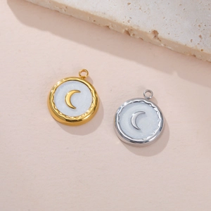 Detailed close-up of crescent moon pendants in gold and silver with pearlescent inlay