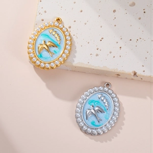 Close-up of pearl-bordered oval pendants with bird and olive branch relief design