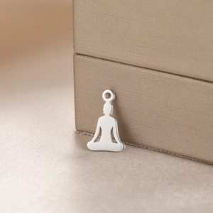 Ciondolo da meditazione in acciaio lucido con silhouette zen su elegante portagioie