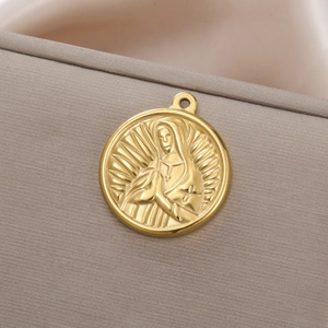 Detailed close-up of golden stainless steel religious medal with Virgin Mary relief carving