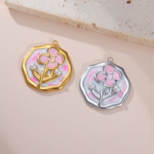 Detailed macro view of enamel flower pendants with pearls on a textured stone background
