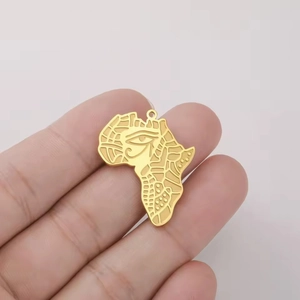 Golden stainless steel Africa map pendant with Eye of Horus design held in hand