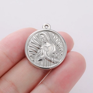 Macro detail of silver stainless steel religious pendant with embossed Our Lady of Guadalupe