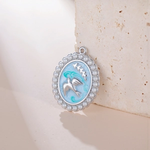 Oval silver necklace pendant with peace dove design and pearl border on stone background