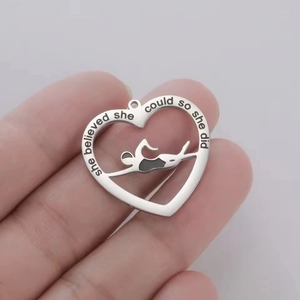 Polished heart pendant with swimming silhouette and inspirational engraved quote