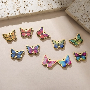 Detailed view of nine colorful butterfly pendants with gold edges for DIY jewelry making