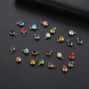 Close-up of colorful round crystal birthstone charms in gold and silver plating