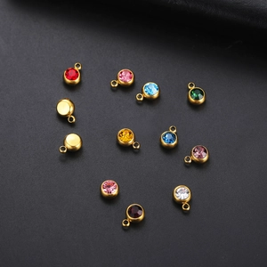 Macro shot of colorful round birthstone pendants with gold plated stainless steel loops