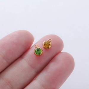 Size reference of green and amber birthstone charms for DIY jewelry making