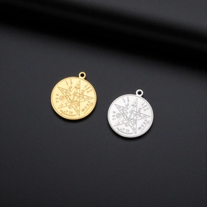 Macro shot of gold and silver Solomon pendants with mystical Tetragrammaton engraving