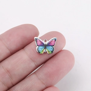 Close-up of a colorful butterfly stainless steel pendant for DIY jewelry making