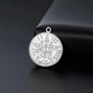 Macro view of etched stainless steel Solomon pendant with mystical symbols and pentagram