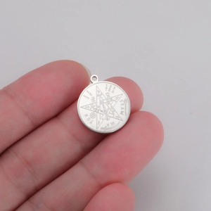 Detailed macro view of silver stainless steel Solomon pentagram pendant with engraving