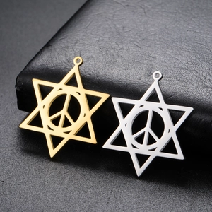 Detailed view of polished gold and silver peace sign hexagram pendants on black leather