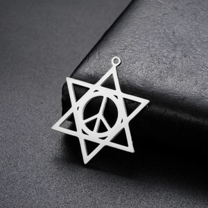 Macro shot of polished stainless steel hexagram and peace symbol charm for DIY jewelry
