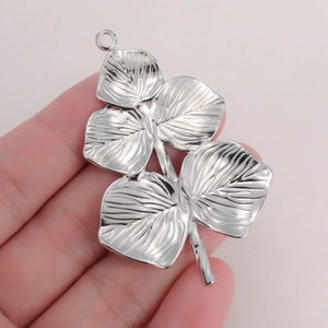 Macro detail of silver stainless steel leaf pendant showing intricate vein texture