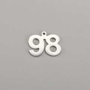 Macro detail of polished stainless steel number 98 pendant with mirror finish and bail