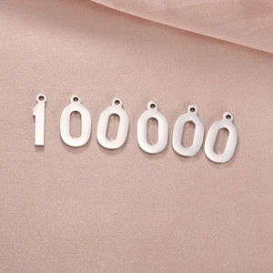 Polished silver 18K gold plated number charms on luxury champagne silk background