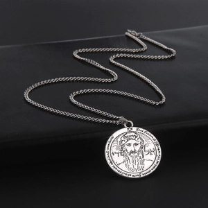 Detailed close-up of a vintage Solomon seal coin pendant with Hebrew carvings and metal chain