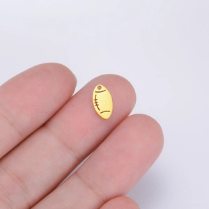 Polished 18K gold rugby bead pendant held by hand for handmade jewelry DIY projects