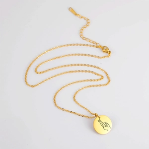 Gold stainless steel necklace with round pendant featuring a lucky gesture engraving