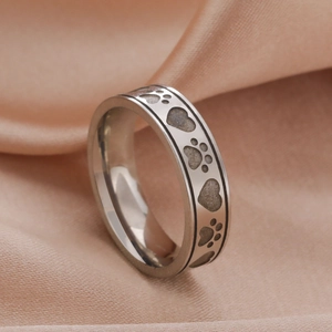 Polished 6mm stainless steel ring with engraved paw prints and hearts on satin
