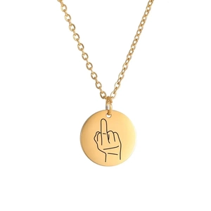 Detail of gold-plated stainless steel round pendant with middle finger gesture engraving