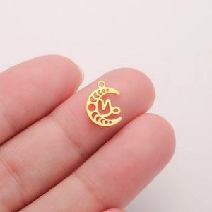 18K gold plated stainless steel crescent moon phase pendant held between fingers
