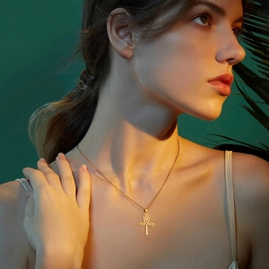 Vintage 18K gold plated hollow cross pendant necklace on a model with exotic details