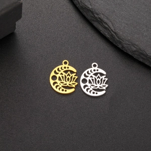 18K gold and silver lotus moon phase pendants displayed on elegant black stone background