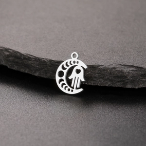 Silver stainless steel moon phase pendant with Hamsa hand and heart cut-out detail