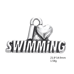 Detailed macro view of antique silver swimming heart charm showing dimensions and texture