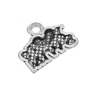 Macro view of antique silver bear pendant with detailed grid texture and loop