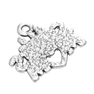 Close-up of heart-shaped hollow pendant with hammered silver texture for DIY jewelry